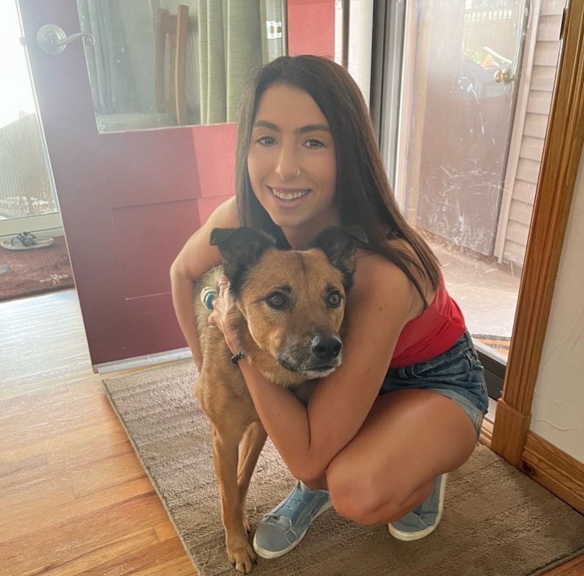 Foster volunteer embracing a rescue dog