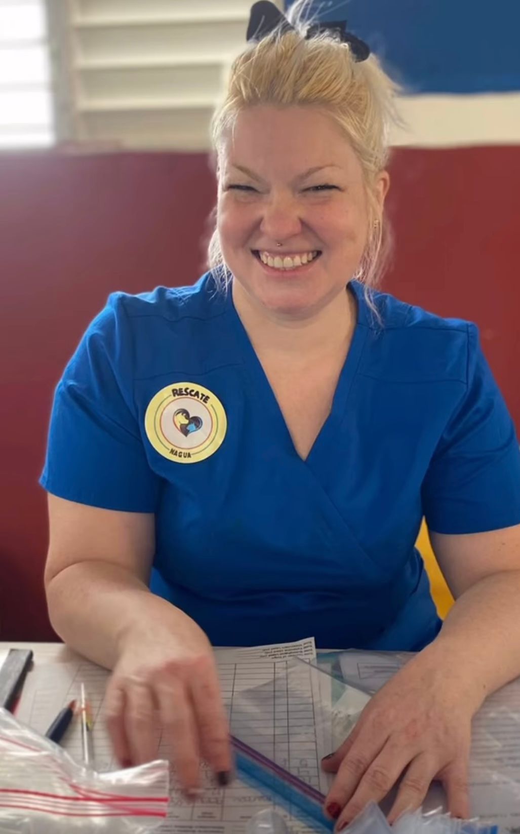 Volunteer preparing paperwork at a table